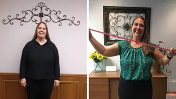 Two women standing in a room with one woman holding something up to her face.