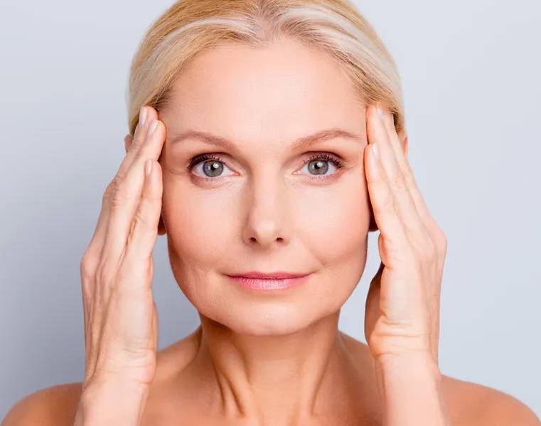 A woman with her hands on her head